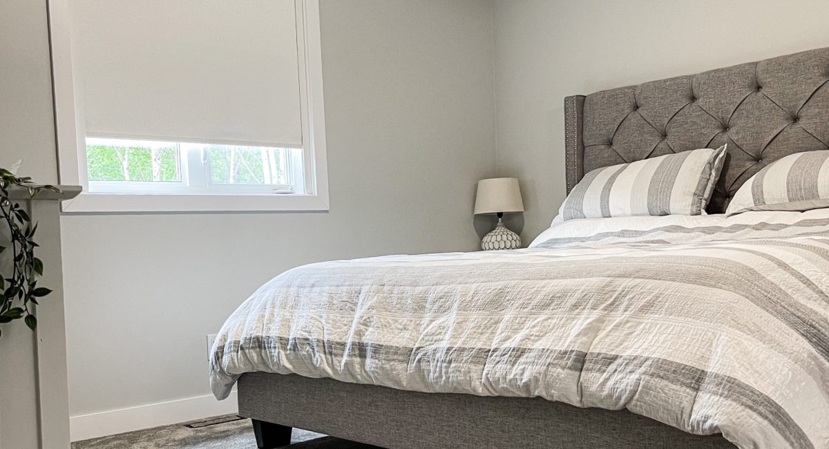 grey bedroom with white window shades